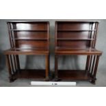 A pair of mid 19th century mahogany bookcases with open upper sections above console bases raised on