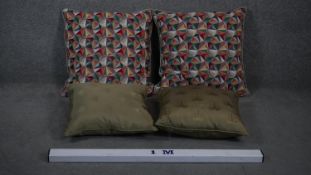 Two pairs of cushions. One set of olive silk covered palm design cushions and a pair of colourful
