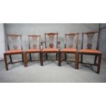 A set of five mahogany Georgian style dining chairs with pierced splats and drop in seats on