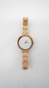 A boxed as new Kerbholz pale wooden watch with copper detailing. White dial with makers name,