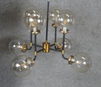 A new in box Mercer glass bubble black And brass chandelier. D.75cm