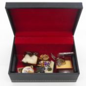A leather effect jewellery box filled with a collection of costume jewellery. Including a sterling