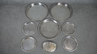 Eight silver plated serving trays. Some with engraved floral and foliate design and the two larger