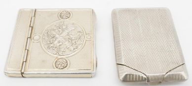 Two sterling silver match books. One French with repousse design, one side with oval cartouche