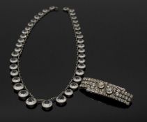 An Art Deco white metal and paste graduated riviera necklace along with a paste set Art Deco white