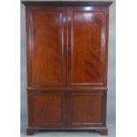An early 19th century mahogany estate cabinet, the dentil cornice above fielded panel doors
