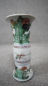 A Chinese Kangxi style Famille Verte ceramic vase decorated with flowers and leaves. Unglazed