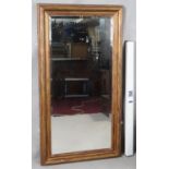 A gilt framed dressing mirror with bevelled plate. H.131 W.69cm