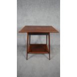 An Edwardian mahogany and satinwood crossbanded occasional table with central fan paterae raised