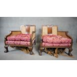 A pair of mid century Georgian style mahogany bergere armchairs with caned backs and sides raised on