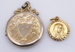A rolled gold foliate engraved round locket with shield shape cartouche. Along with a 9 carat gold