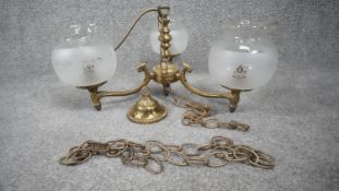 A vintage three branch scrolling design brass chandelier with frosted glass etched floral design