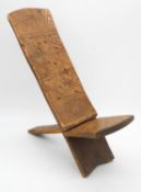 A child's African hardwood palaver chair with carved geometric detail. H.50cm