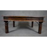 An Indian teak metal bound low table on circular supports. H.39 L.93 D.60cm