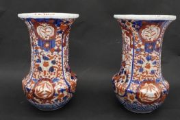 A pair of Meji period Japanese Imari ceramic vases. Decorated with floral and foliate motifs,