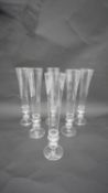 A set of six Venetian style hand blown clear glass champagne flutes. with hollow glass feet. H.23
