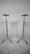 A pair of wrought iron floor standing candle sticks. H.62 W.25 D.25