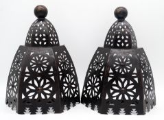 A pair of pierced metal geometric design wall mounted lanterns. H.43cm