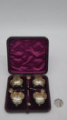 A Victorian cased sterling silver salt set. The case with a plum silk and velour lining. Four