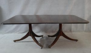 A Georgian style mahogany twin pillar dining table on reeded swept supports. H.72 L.196.5 W.122cm
