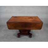 A 19th century mahogany drop flap Pembroke dining table with frieze drawer on facetted pedestal