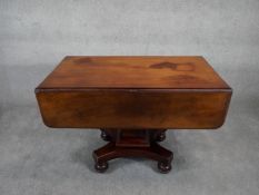 A 19th century mahogany drop flap Pembroke dining table with frieze drawer on facetted pedestal