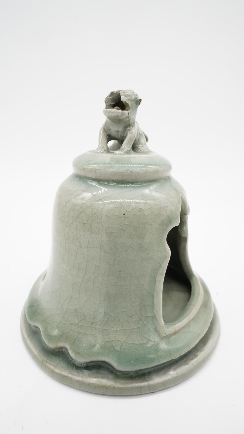 A celadon glaze ceramic tea light holder with foo dog finial. H.17cm - Image 2 of 4