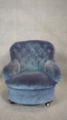 A 19th century bedroom chair in deep buttoned upholstery on mahogany bun feet. H.76 W.64 D.69cm