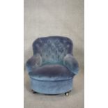 A 19th century bedroom chair in deep buttoned upholstery on mahogany bun feet. H.76 W.64 D.69cm