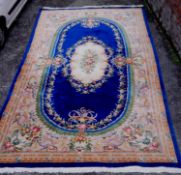 A large Aubusson motif Chinese carpet with blue ground. L.500 W.250cm