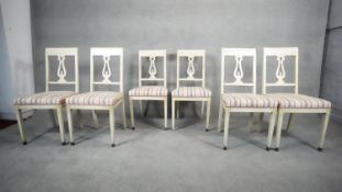 A set of six painted Continental dining chairs with pierced lyre shaped splats and gilt decoration