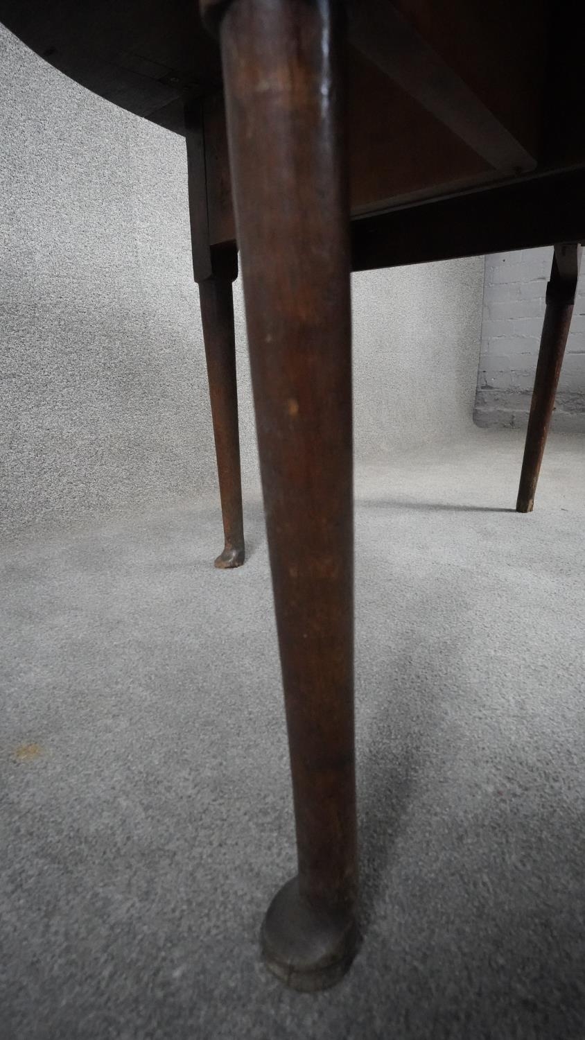 A Georgian oak drop flap dining table on pad foot supports. H.72 W.110 D.45 Ext.113 - Image 7 of 10