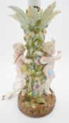 A 20th century Sitzendorf hand painted porcelain table lamp with three cherub figures and the stem