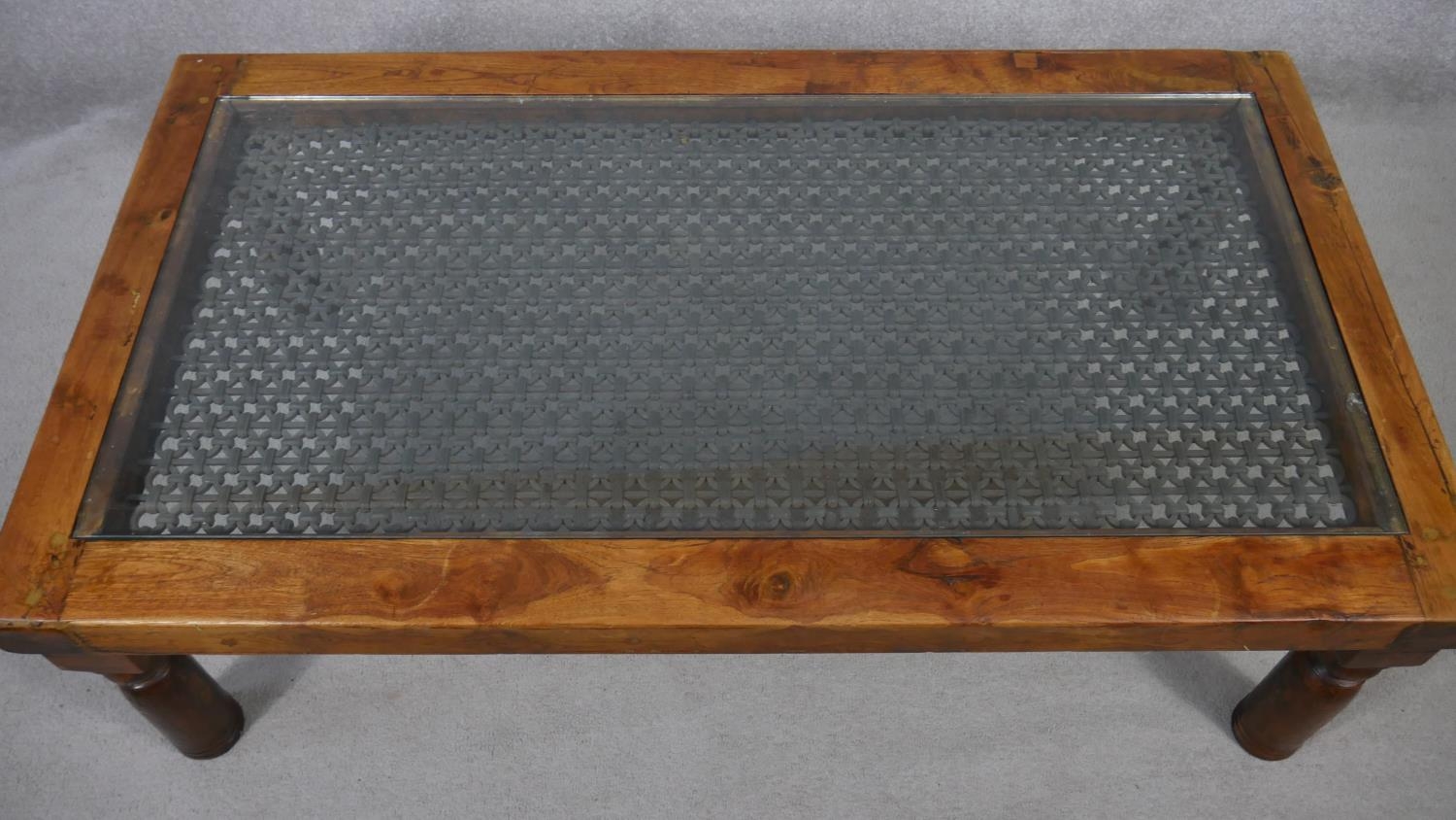An Indian hardwood coffee table with plate glass on a metal lattice work inset top. H.41 L.132 W. - Image 2 of 5