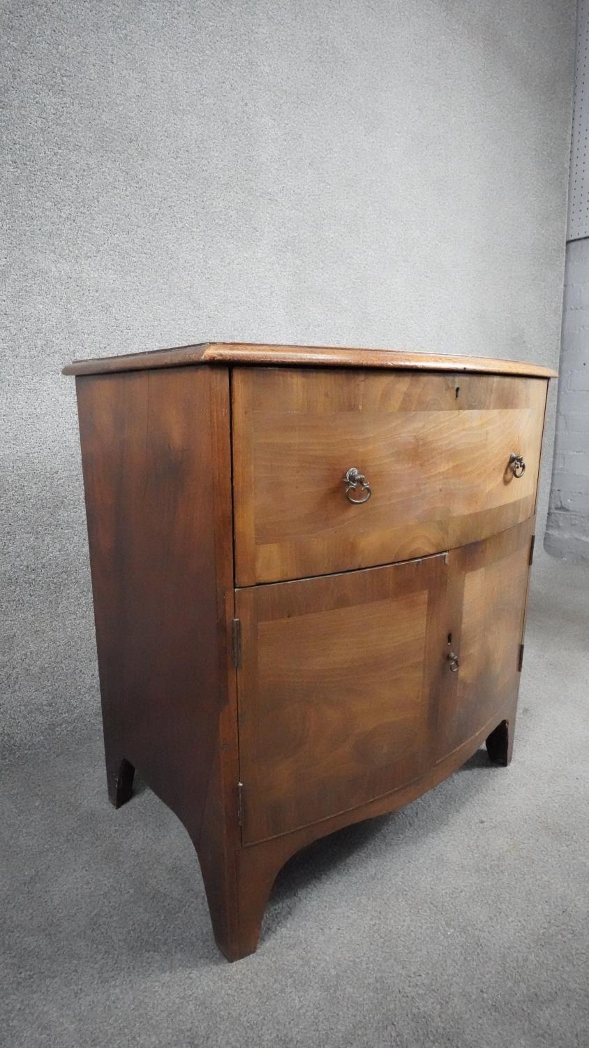 A Georgian mahogany and crossbanded bedside cabinet on shaped swept bracket feet. H.71 W.65 D.39 - Image 4 of 5