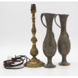 A pair of patinated brass vases with wrapped handles along with a brass foliate design table lamp.