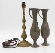 A pair of patinated brass vases with wrapped handles along with a brass foliate design table lamp.