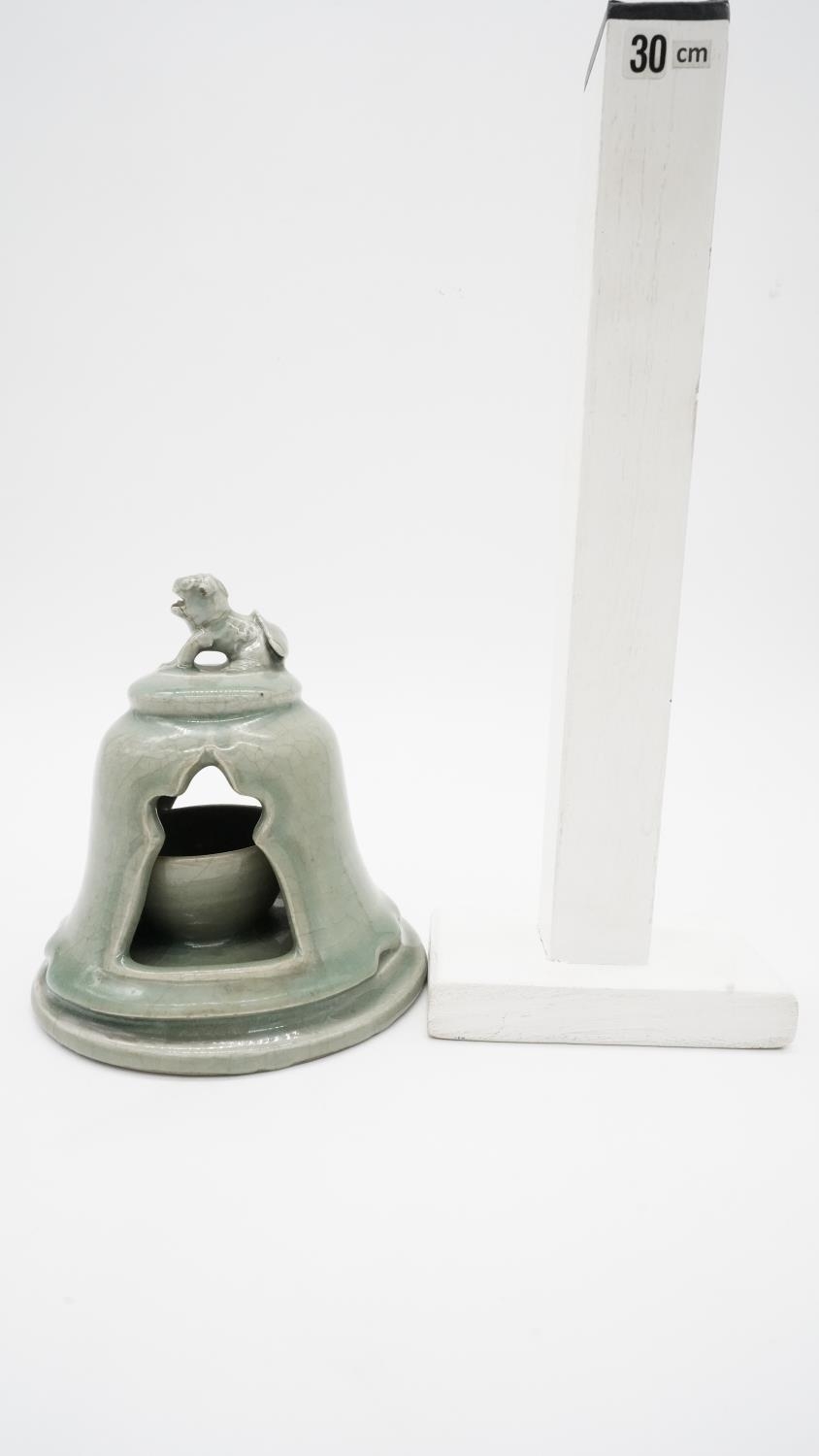 A celadon glaze ceramic tea light holder with foo dog finial. H.17cm - Image 4 of 4