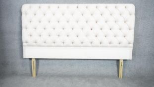 A contemporary upholstered headboard in deep buttoned calico for a 6ft mattress. H.125 W.179cm