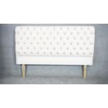 A contemporary upholstered headboard in deep buttoned calico for a 6ft mattress. H.125 W.179cm