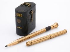 Two rolled gold pens and a travel Asprey's leather gilded vesta case. One of the rolled gold