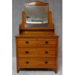 A Victorian satin walnut dressing chest with swing mirror above three long drawers. H.160 W.90 D.