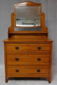 A Victorian satin walnut dressing chest with swing mirror above three long drawers. H.160 W.90 D.
