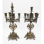 A pair of antique style cast brass five branch candelabras with floral and bird design. With flame