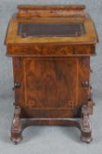 A 19th century figured walnut and satinwood inlaid Davenport with leather lined writing slope