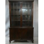 A C.1900 mahogany Georgian style bookcase with window pane glazed upper section enclosing
