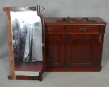 A 19th century mahogany mirror backed sideboard with arched plate above drawers and panel doors on