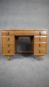 A mid century vintage light oak dressing table with central lift up vanity mirror. H.77 W.106 D.47