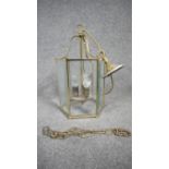 A Victorian style brass and glass porch lantern. The lamp of a hexagonal form with six bevelled