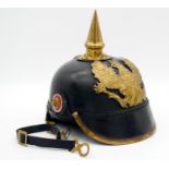A Prussian Pickelhaube, leather bodied helmet with brass spike and plate marked Mit Gott Fur Konig